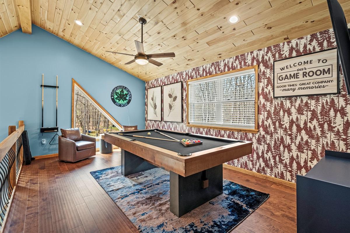 Game Room: Enjoy friendly competition with a stylish pool table and nature views through large windows!