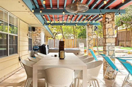 Enjoy alfresco dining at its finest in this beautifully designed covered patio. Whether you are starting your morning with a fresh cup of coffee or gathering for a lively dinner under the glow of string lights, every meal feels extra special.